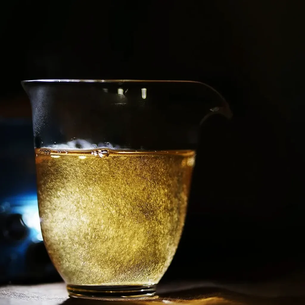 The white tea liquor in the fairness cup is filled with fine hairs from the buds.